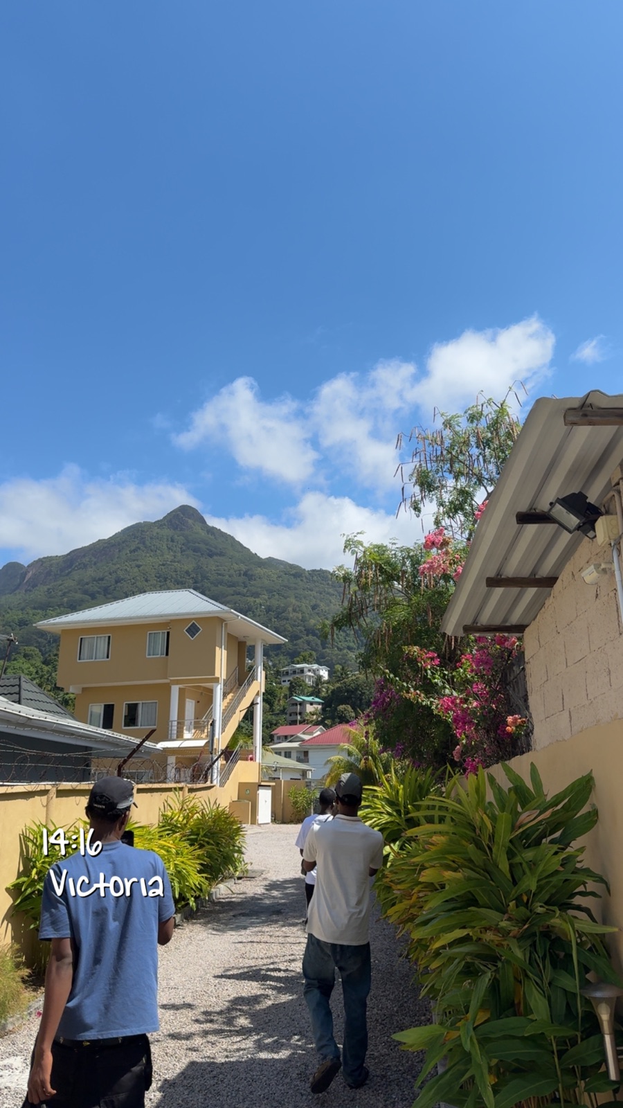 Guests walking in Victoria Seychelles with mountain views